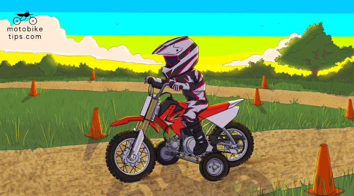A kid on a mini dirt bike with training wheels getting trained