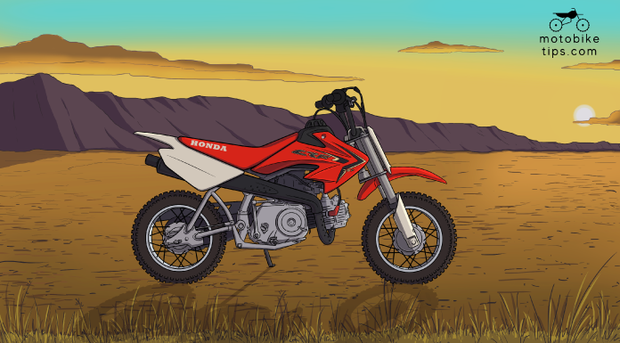 Red Honda 50cc Dirt Bike CRF50 on off-roading area with mountain and sun in the background
