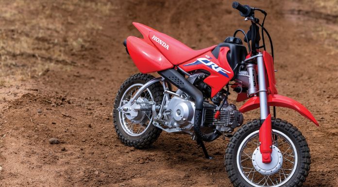 Image of Honda CRF50F dirt bike on a stand in the ground.