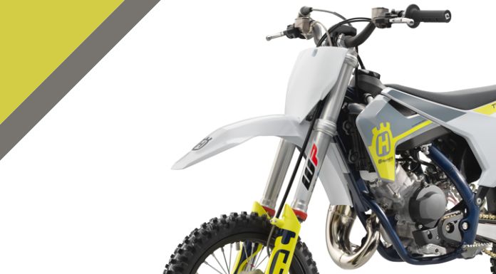 Side view image of Husqvarna 65 dirt bike in white background with yellow and gray corner design