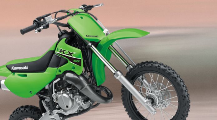 Side view image of Kawasaki kx65 in blurry background