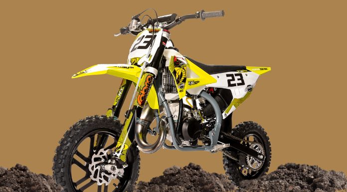 Isolated image of Cobra 50cc dirt bike in brown background with dirt at the bottom