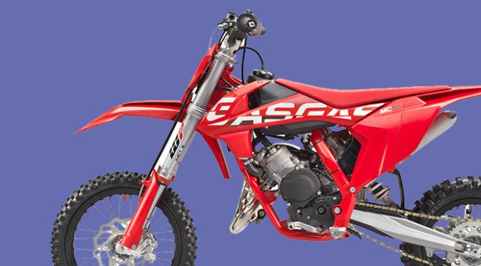 Side view image of Gasgas 65 dirt bike in light blue background