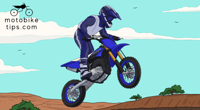 Kid jumping the yamaha yz 65 dirt bike in the trail with beautiful blue sky background