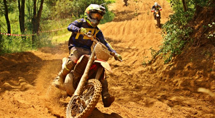 Man on motocross riding his dirt bike in the mud