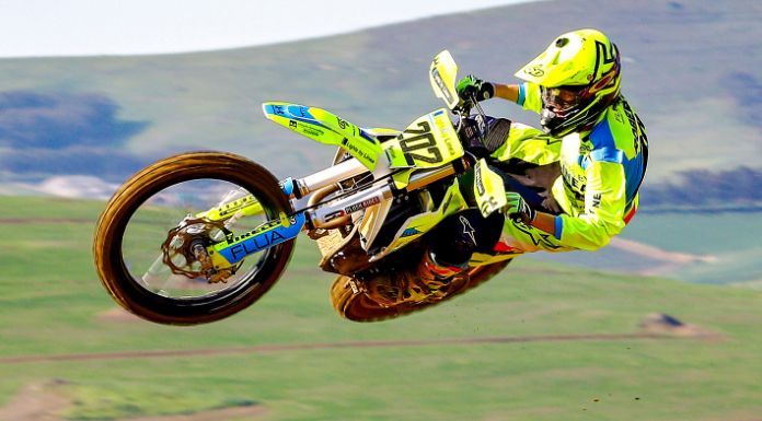 Man jumping off his dirt bike in the field