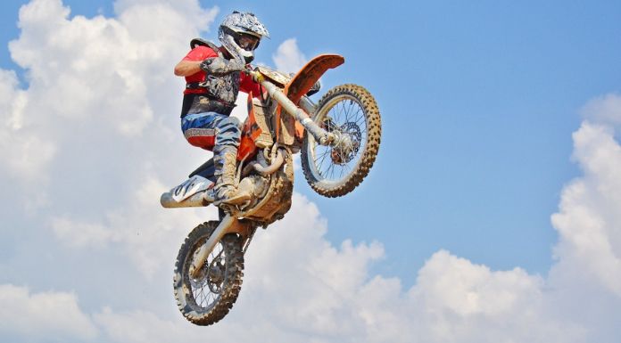Man jumping off his dirtbike in motocross