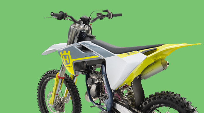 Side view image of Husqvarna TC 85 in green background