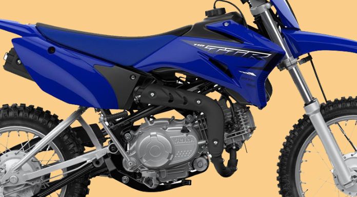 Focus image of the engine of yamaha ttr 110 dirt bike in beige background 