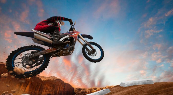 Motocross rider jumping off his dirt bike