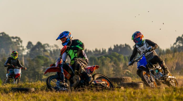 Motocross riders on competition, riding their bike in the trail