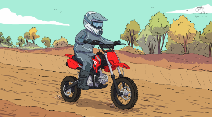 Young man riding on his ssr 110 dirt bike with trees on his side
