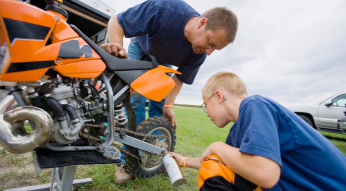 Father and son fixing a dirt bike