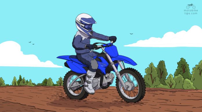 Young man riding on his Yamaha TTR110 pit bike in the trail